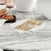 Novara White Marble Black Leg Round Dining Table & 4 Cream Pesaro Black Leg Chairs